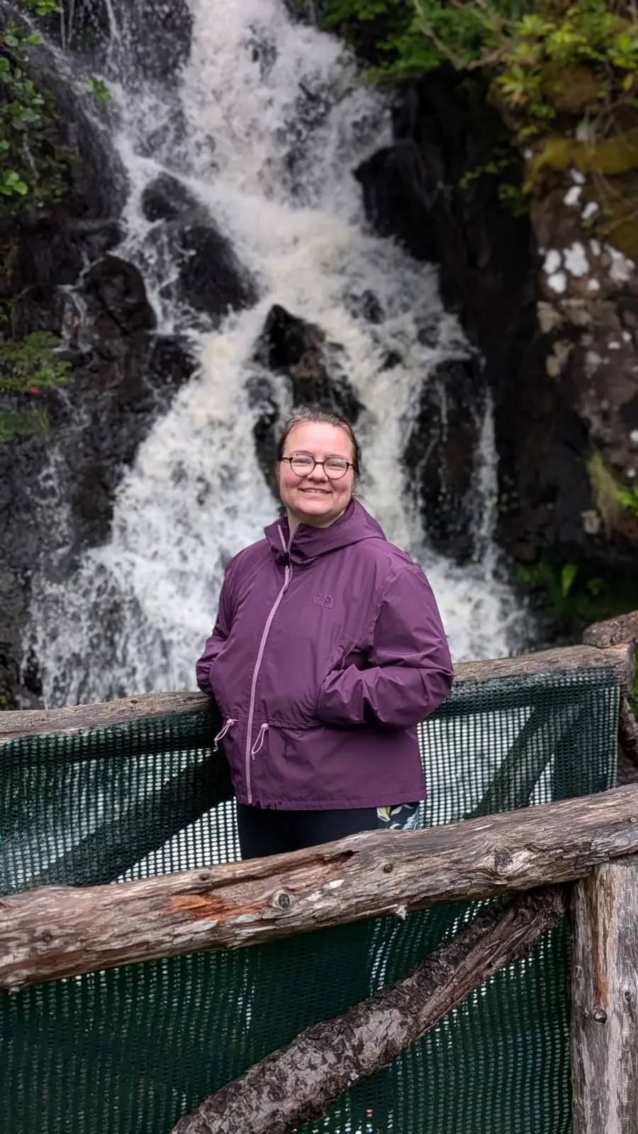 Manon hiking in front of a waterfall